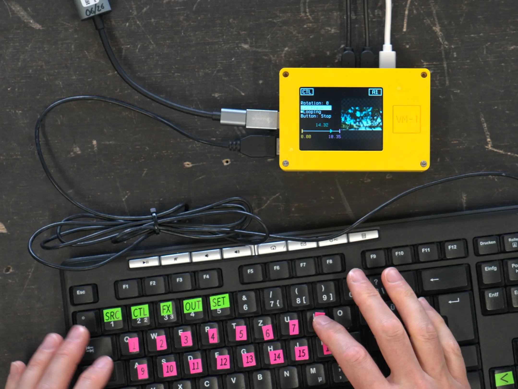 Hands are controlling the VM-1 using a standard keyboard
