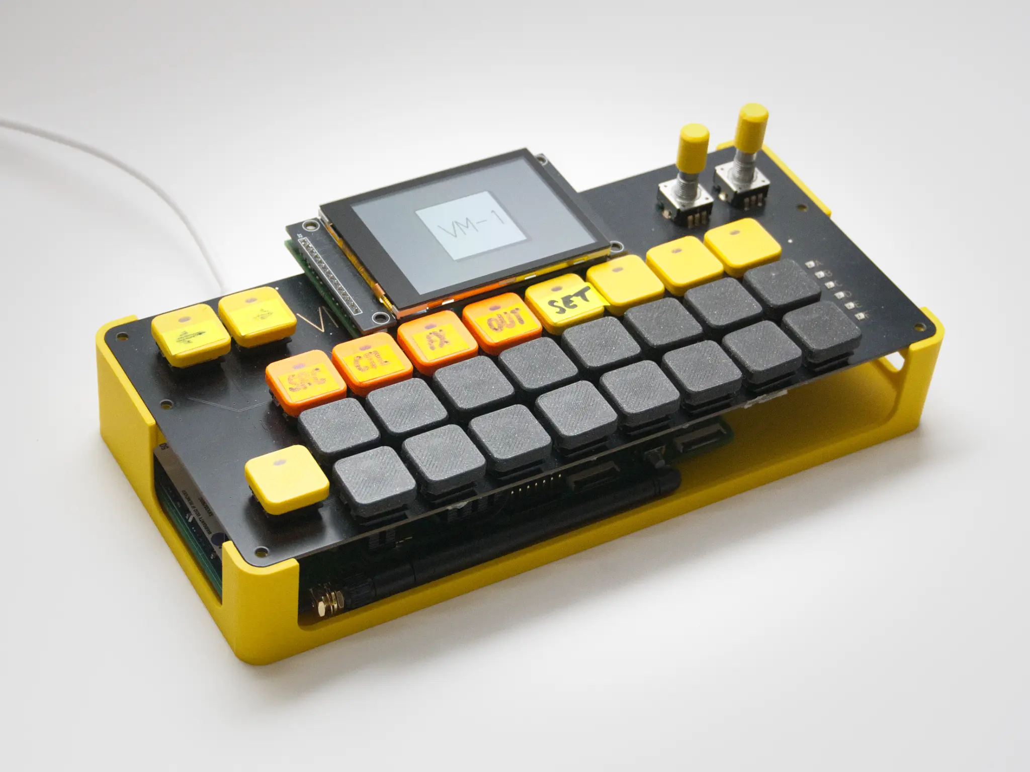 A prototype of the VM-1 Pro with yellow and black keys and a small display